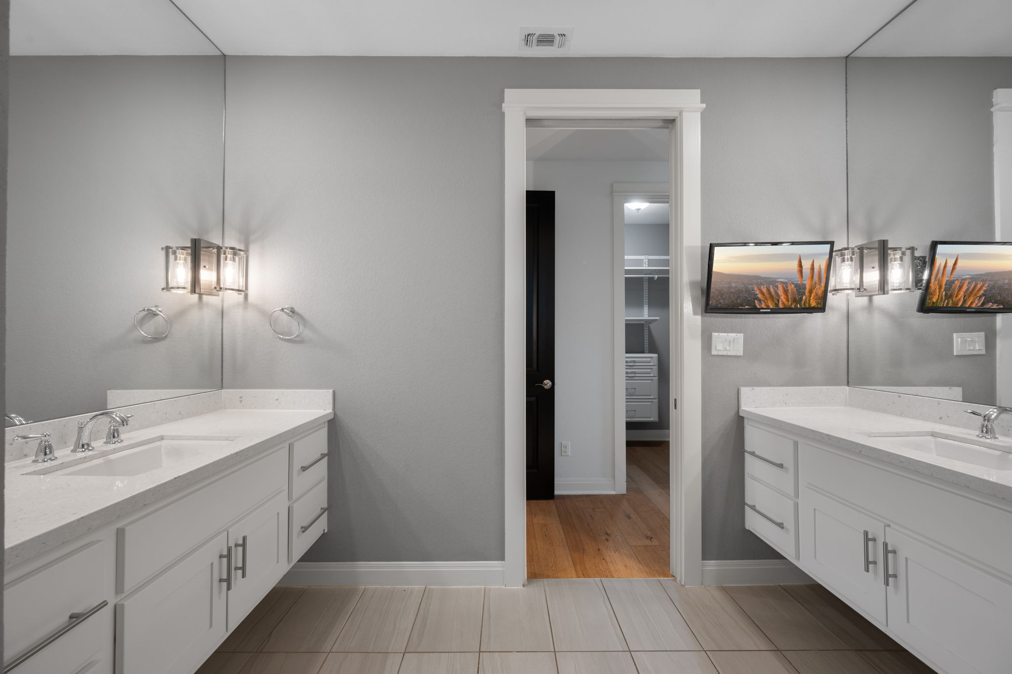 13708 Golden Wave Loop Austin, TX 78738 - Photo 19 of 34 Bathroom featuring a vanity with a white countertop and dual sinks, complemented by contemporary light fixtures