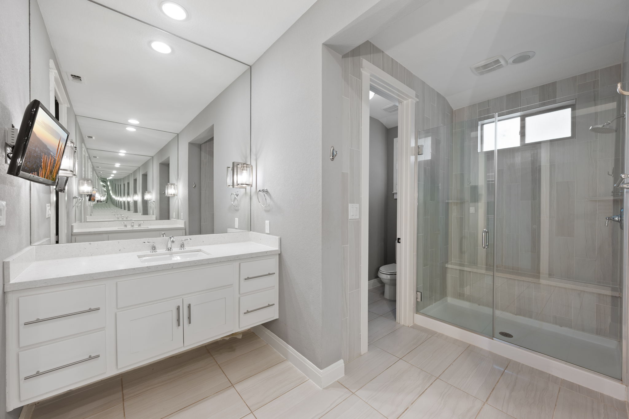 13708 Golden Wave Loop Austin, TX 78738 - Photo 20 of 34 The bathroom features a spacious vanity with a double sink, a large mirror, and recessed lighting