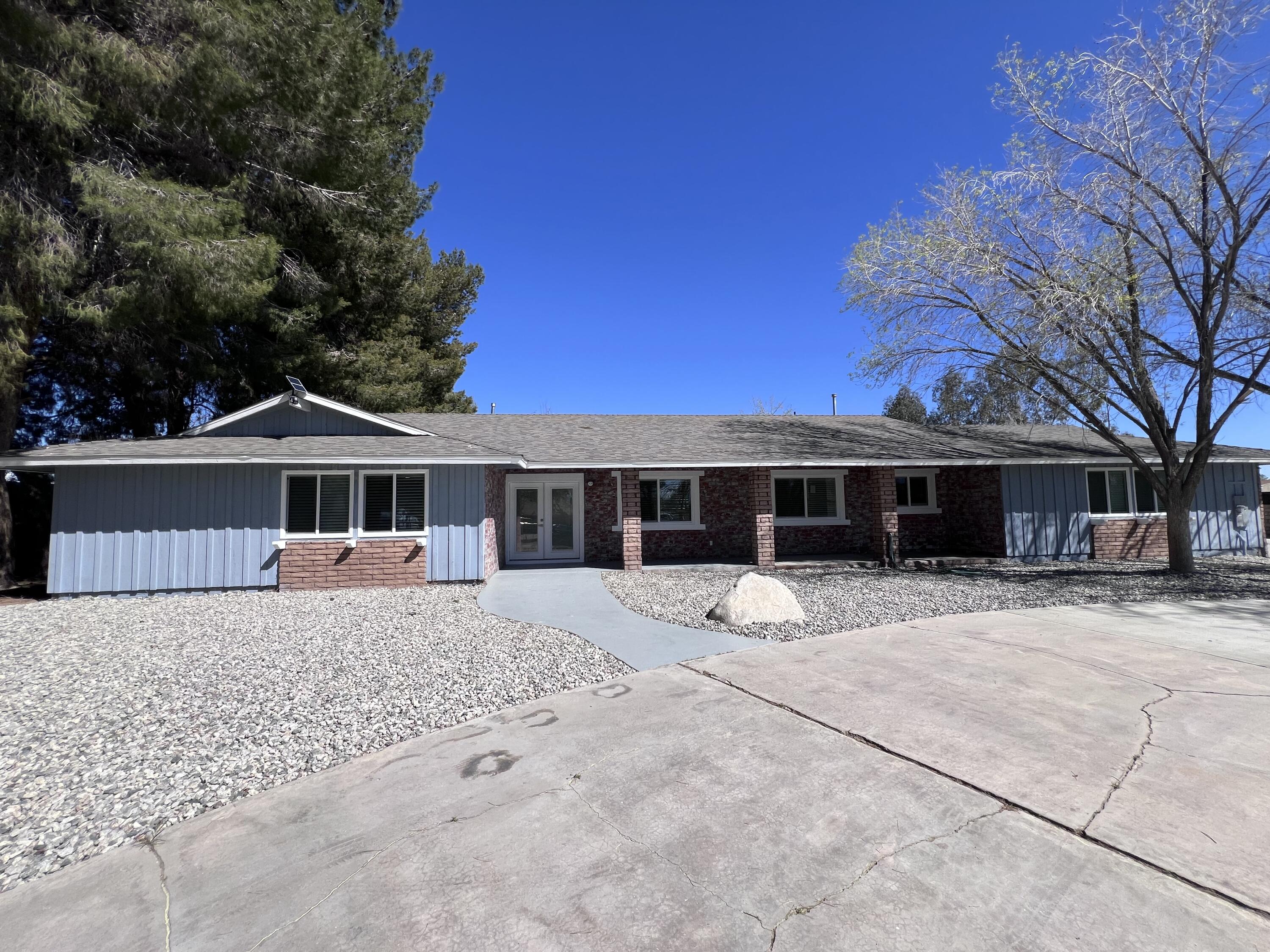 3255 East E Avenue Lancaster, CA 93535 - Photo 1 of 81 a front view of a house with a yard