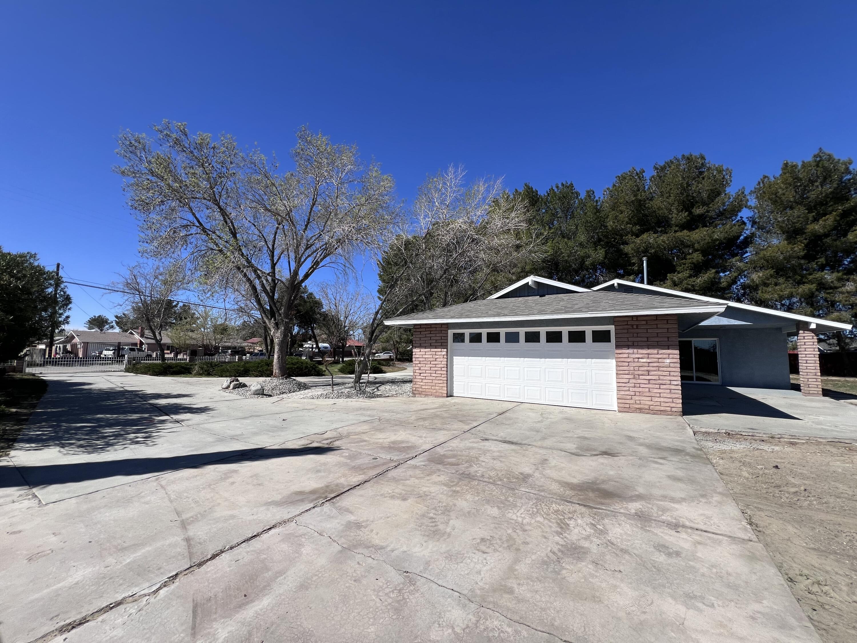 3255 East E Avenue Lancaster, CA 93535 - Photo 13 of 81 a view of a house with a yard