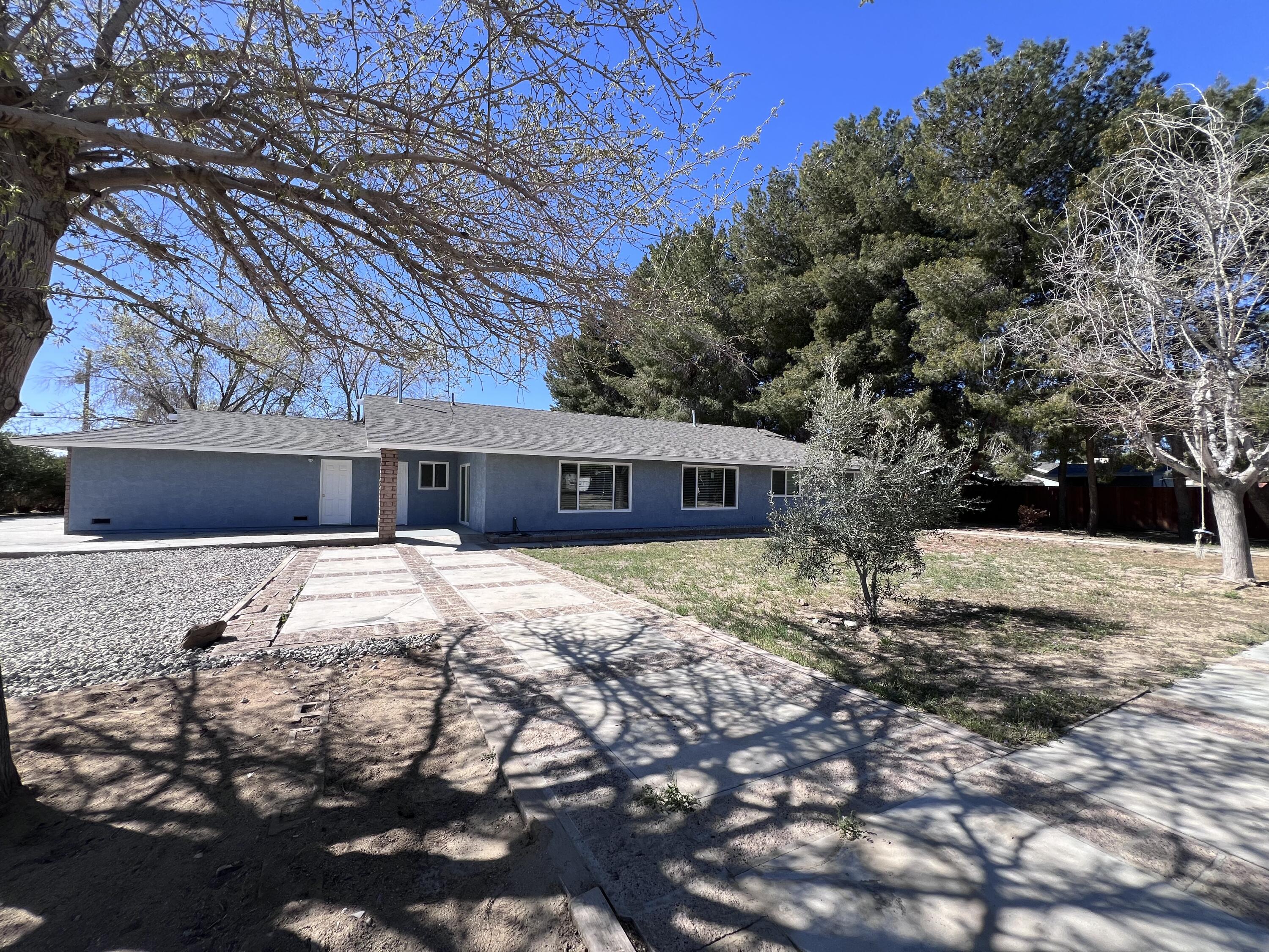 3255 East E Avenue Lancaster, CA 93535 - Photo 15 of 81 a view of a house with a yard covered in snow