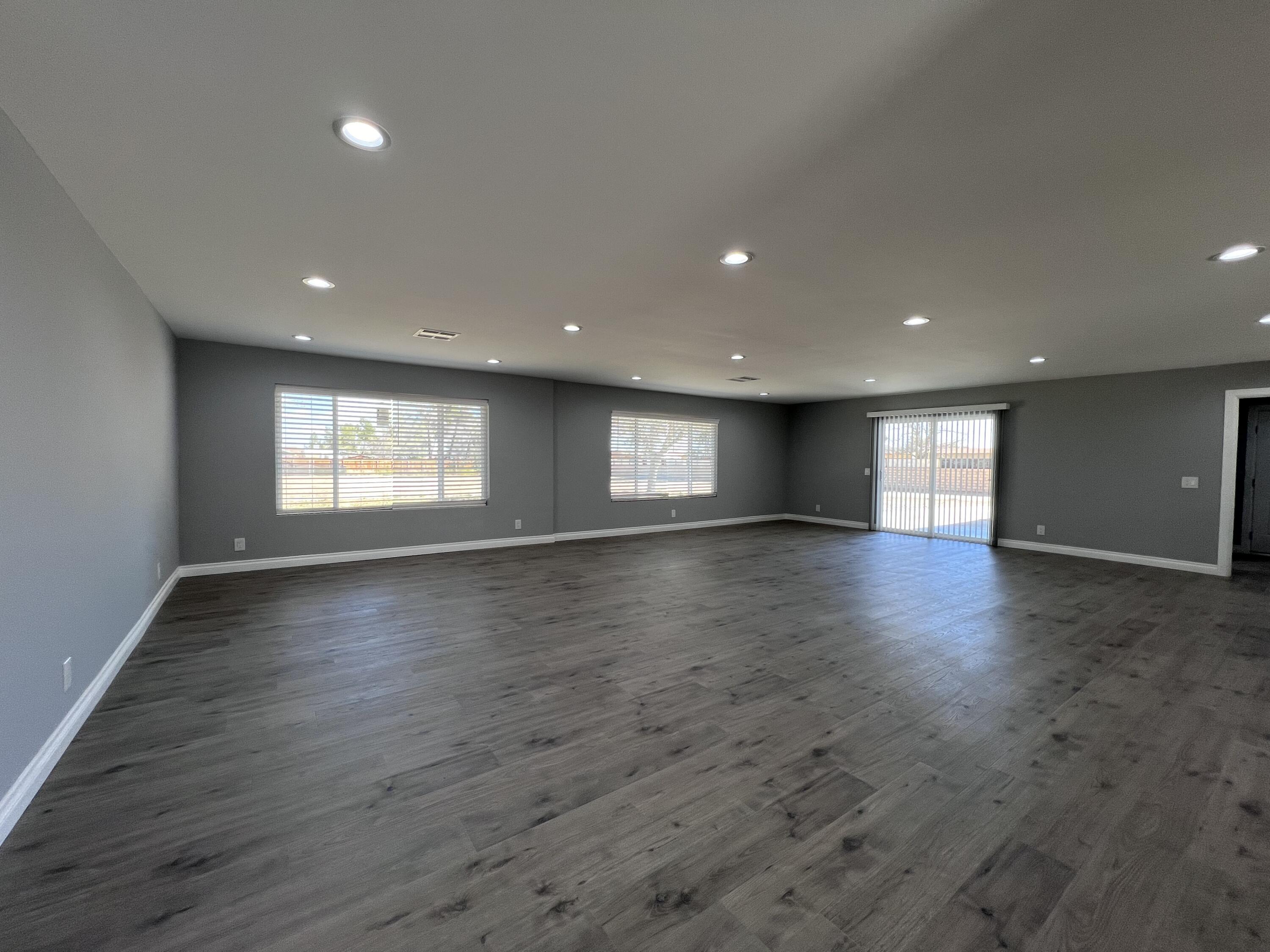 3255 East E Avenue Lancaster, CA 93535 - Photo 19 of 81 a view of empty room with window and wooden floor