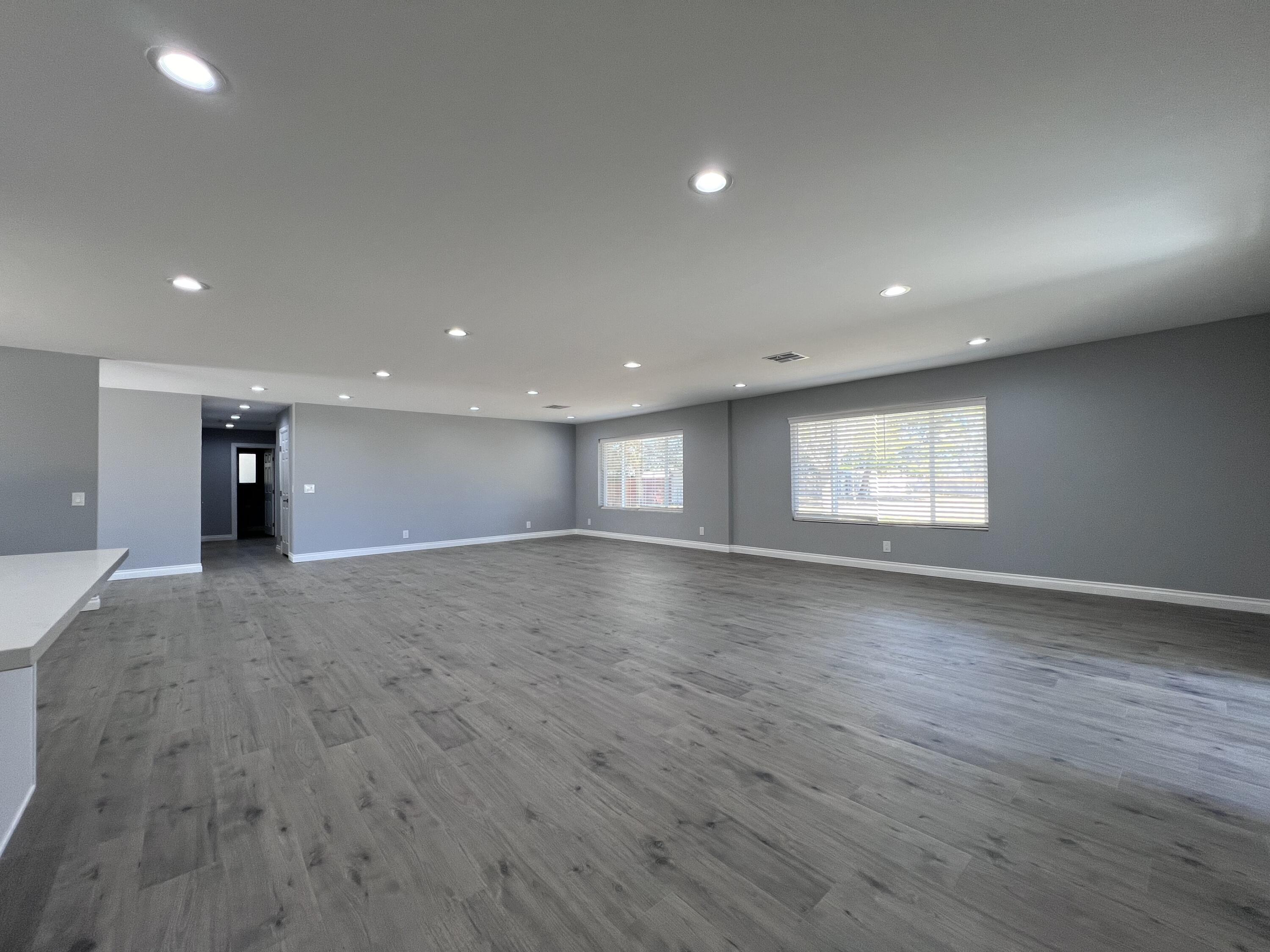 3255 East E Avenue Lancaster, CA 93535 - Photo 22 of 81 an empty room with wooden floor and window