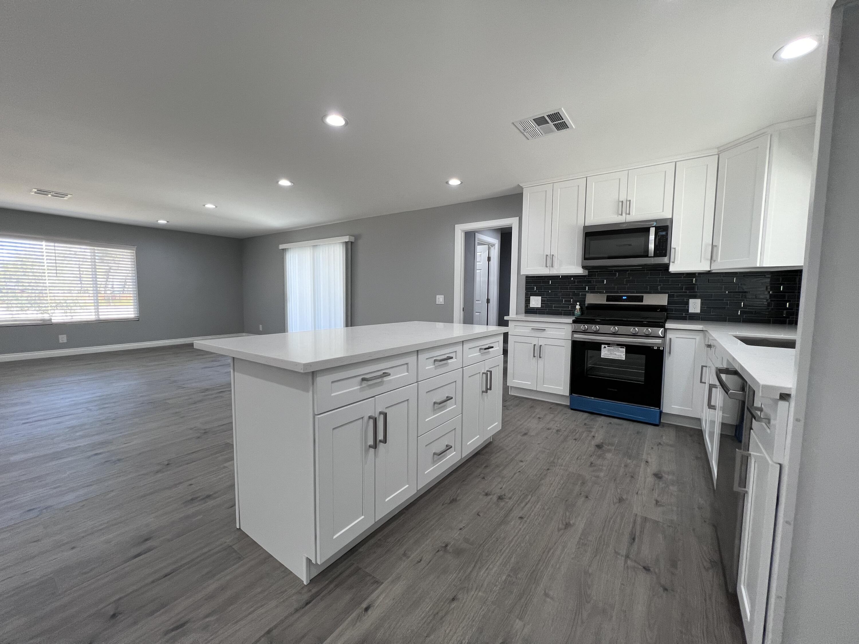 3255 East E Avenue Lancaster, CA 93535 - Photo 27 of 81 a kitchen with stainless steel appliances granite countertop a stove a sink and a refrigerator