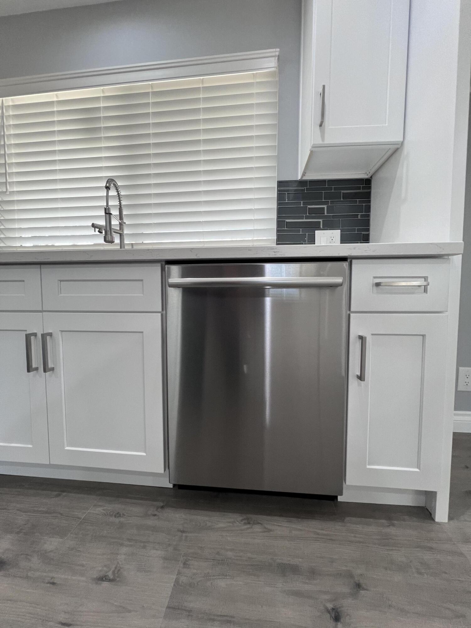 3255 East E Avenue Lancaster, CA 93535 - Photo 30 of 81 a kitchen with granite countertop cabinets stainless steel appliances and a window