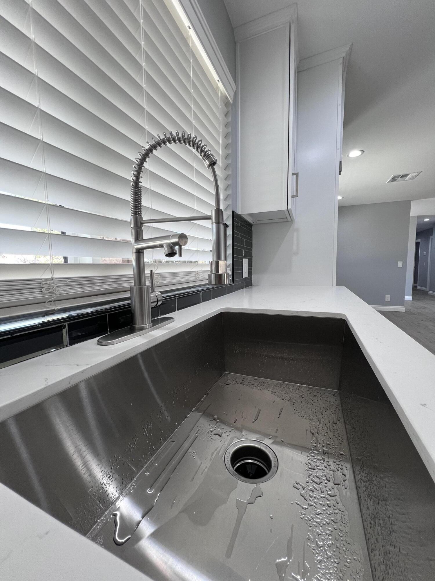 3255 East E Avenue Lancaster, CA 93535 - Photo 32 of 81 a kitchen with a sink and a stove