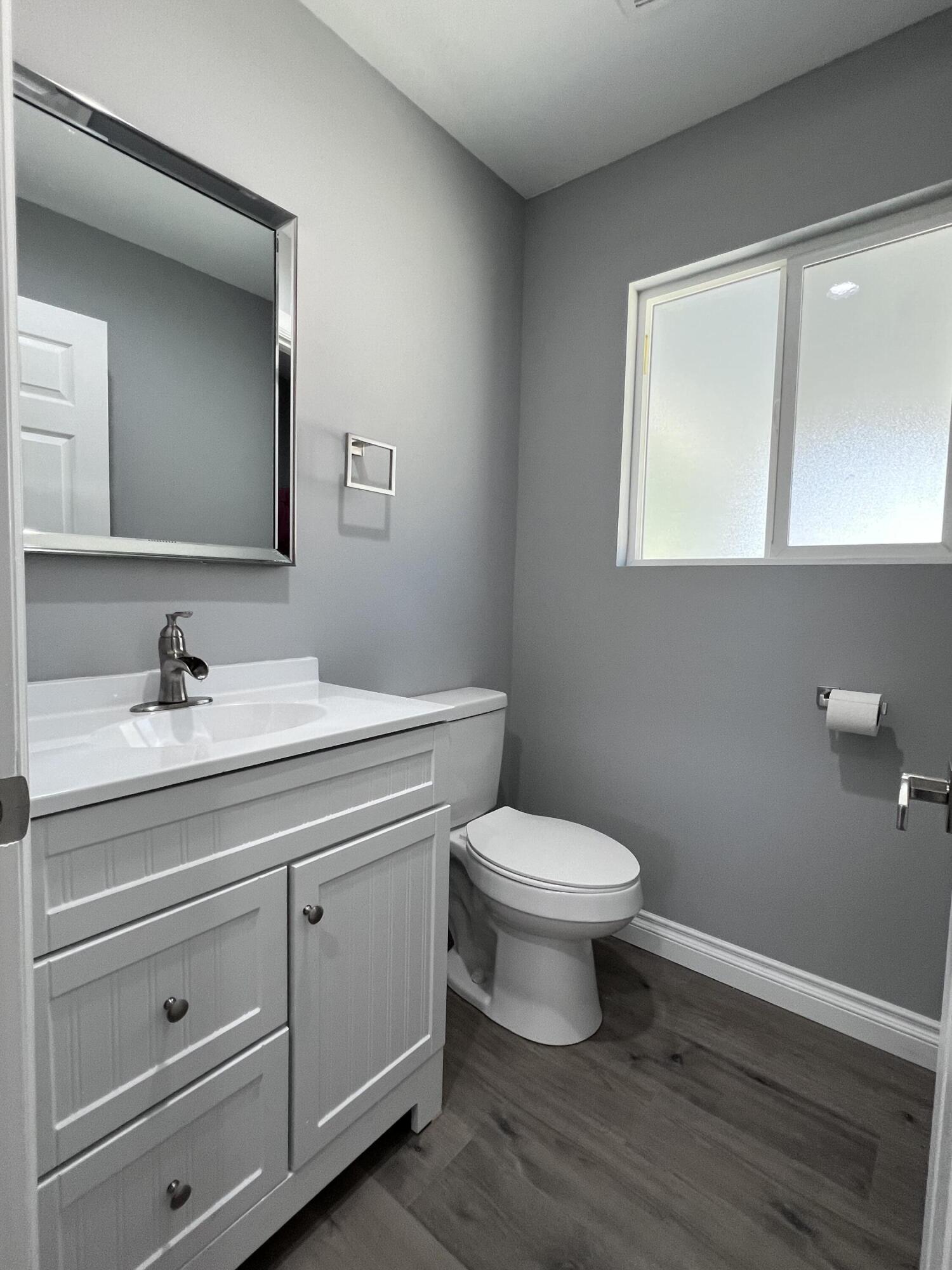 3255 East E Avenue Lancaster, CA 93535 - Photo 37 of 81 a bathroom with a toilet sink and mirror