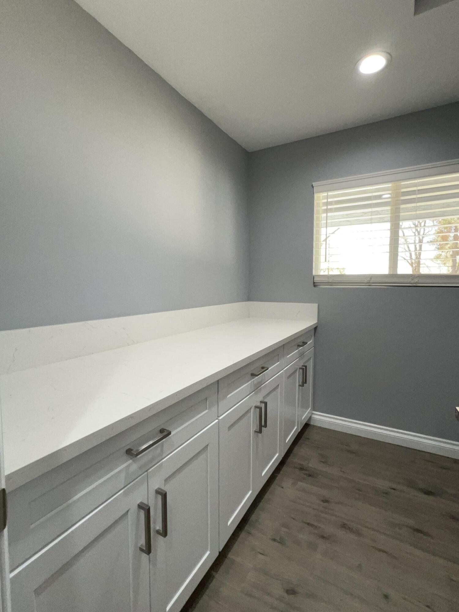 3255 East E Avenue Lancaster, CA 93535 - Photo 40 of 81 a view of an empty room with wooden floor and a window