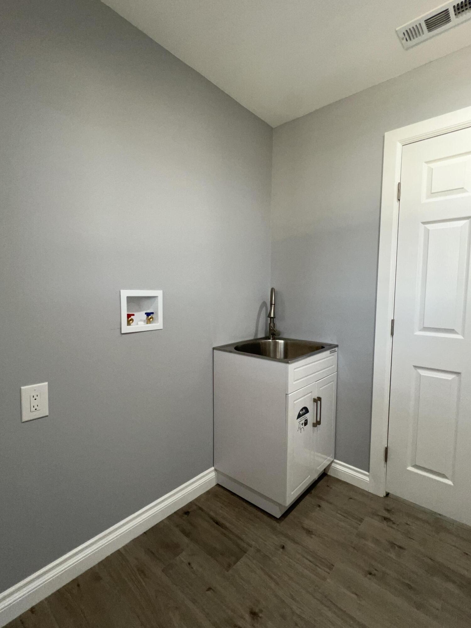 3255 East E Avenue Lancaster, CA 93535 - Photo 41 of 81 a hallway with a wooden floor
