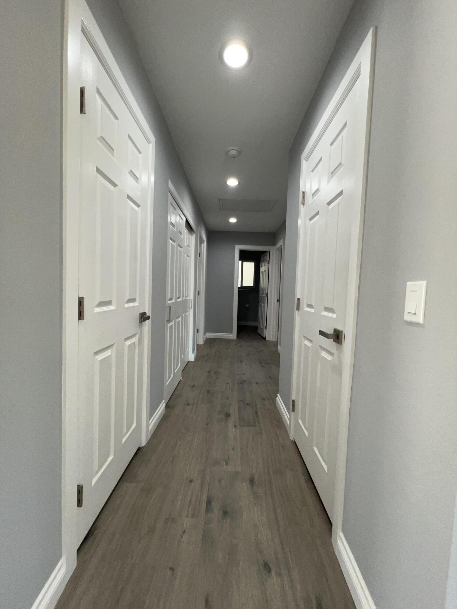 3255 East E Avenue Lancaster, CA 93535 - Photo 43 of 81 a view of a hallway with wooden floor