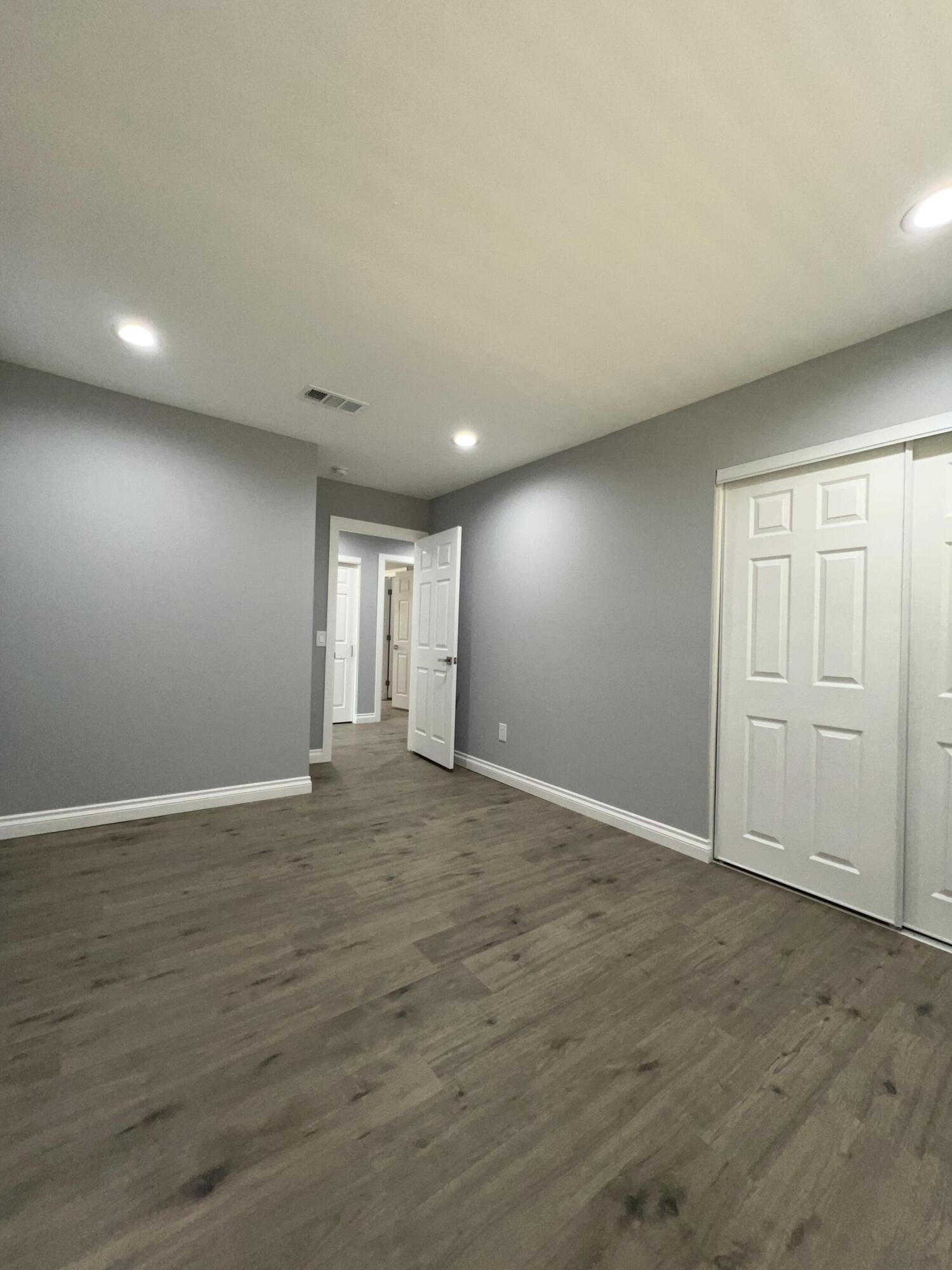 3255 East E Avenue Lancaster, CA 93535 - Photo 46 of 81 a view of an empty room with wooden floor and closet
