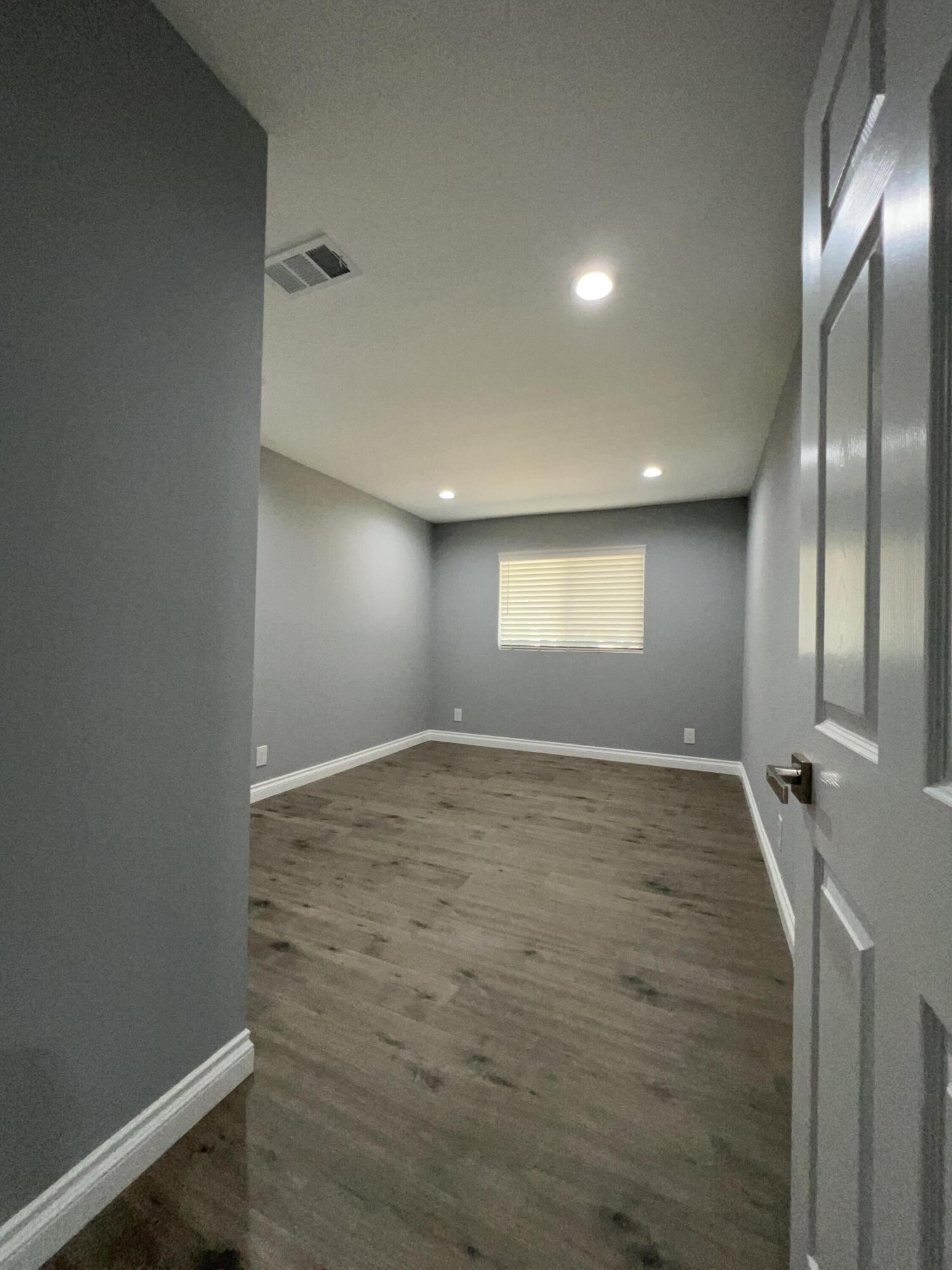 3255 East E Avenue Lancaster, CA 93535 - Photo 47 of 81 a view of empty room with window and wooden floor
