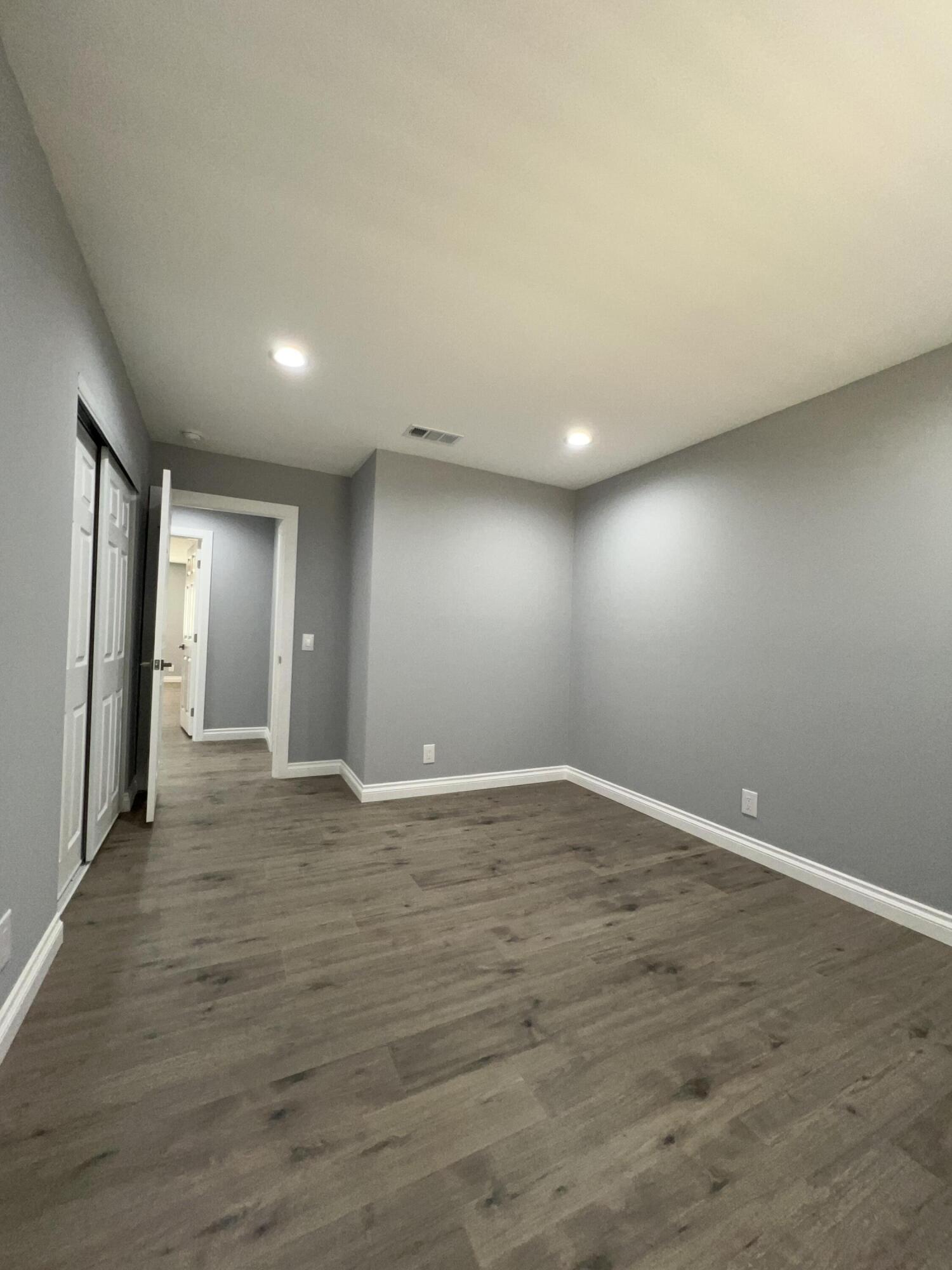 3255 East E Avenue Lancaster, CA 93535 - Photo 48 of 81 a view of an empty room with wooden floor