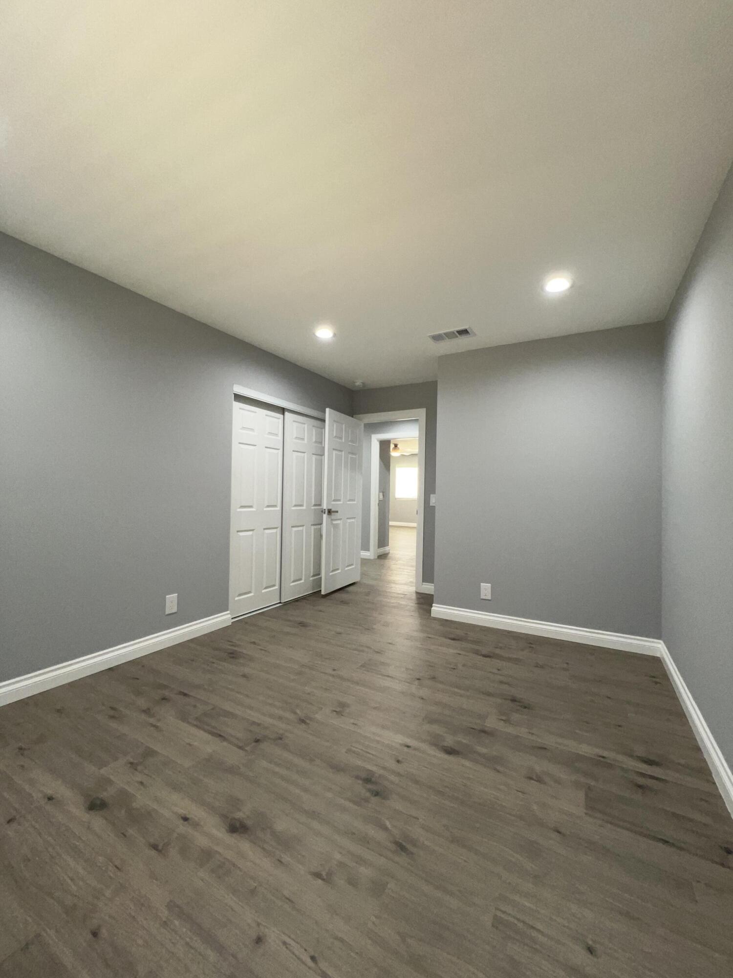 3255 East E Avenue Lancaster, CA 93535 - Photo 49 of 81 a view of an empty room with wooden floor