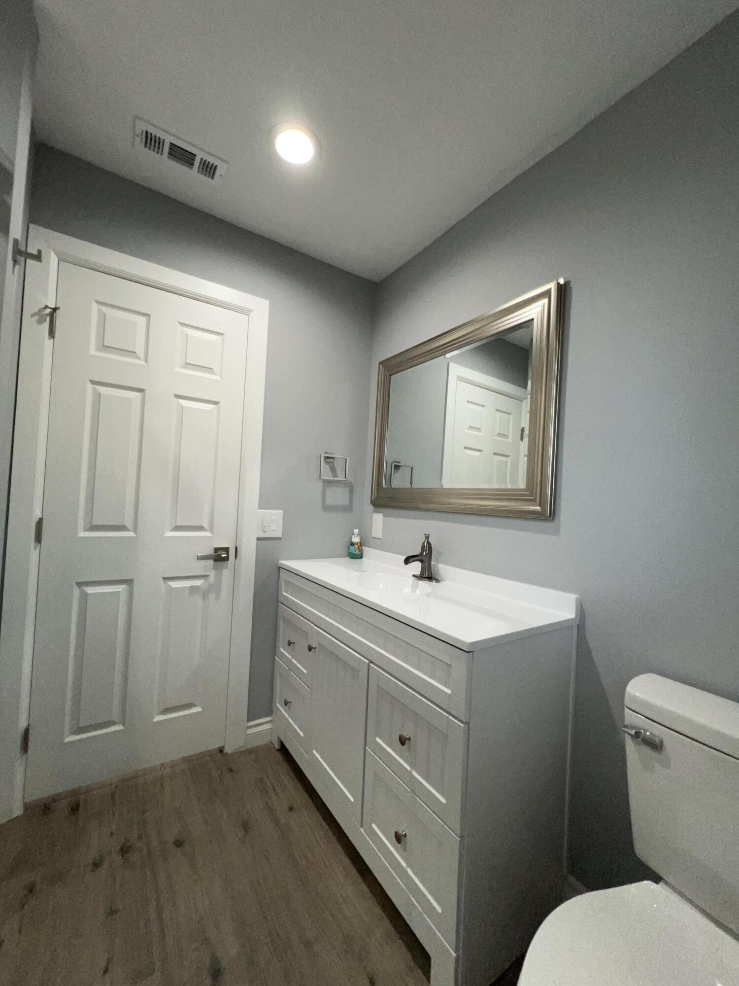 3255 East E Avenue Lancaster, CA 93535 - Photo 51 of 81 a bathroom with a toilet sink and mirror