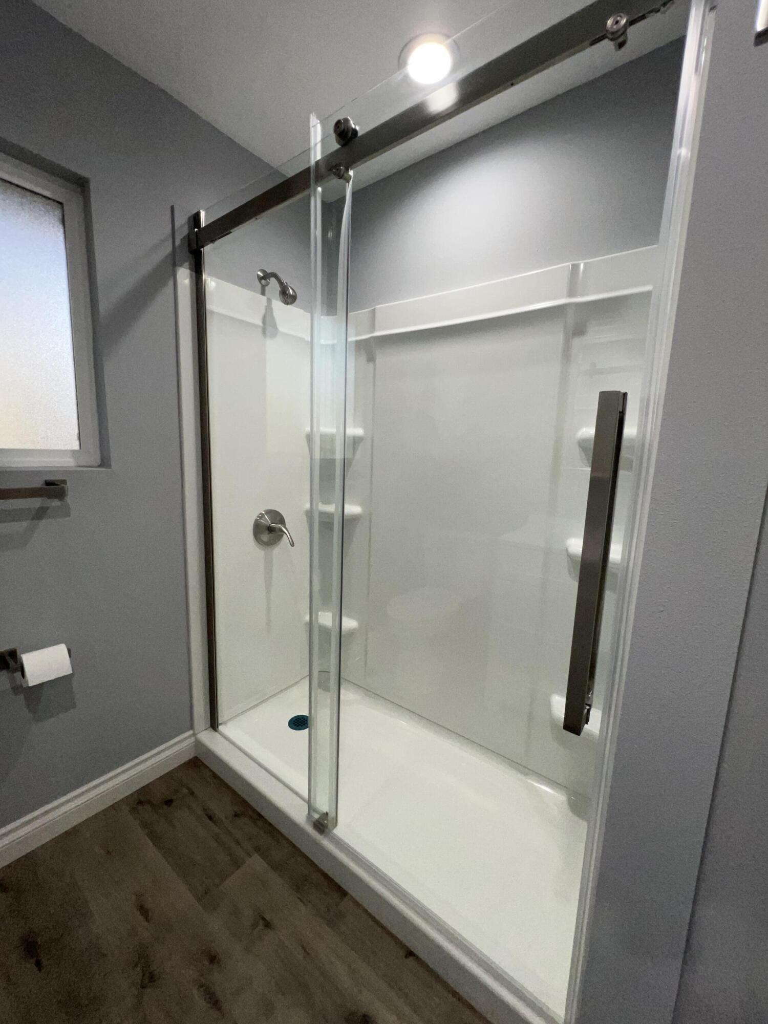 3255 East E Avenue Lancaster, CA 93535 - Photo 52 of 81 a bathroom with a glass shower door