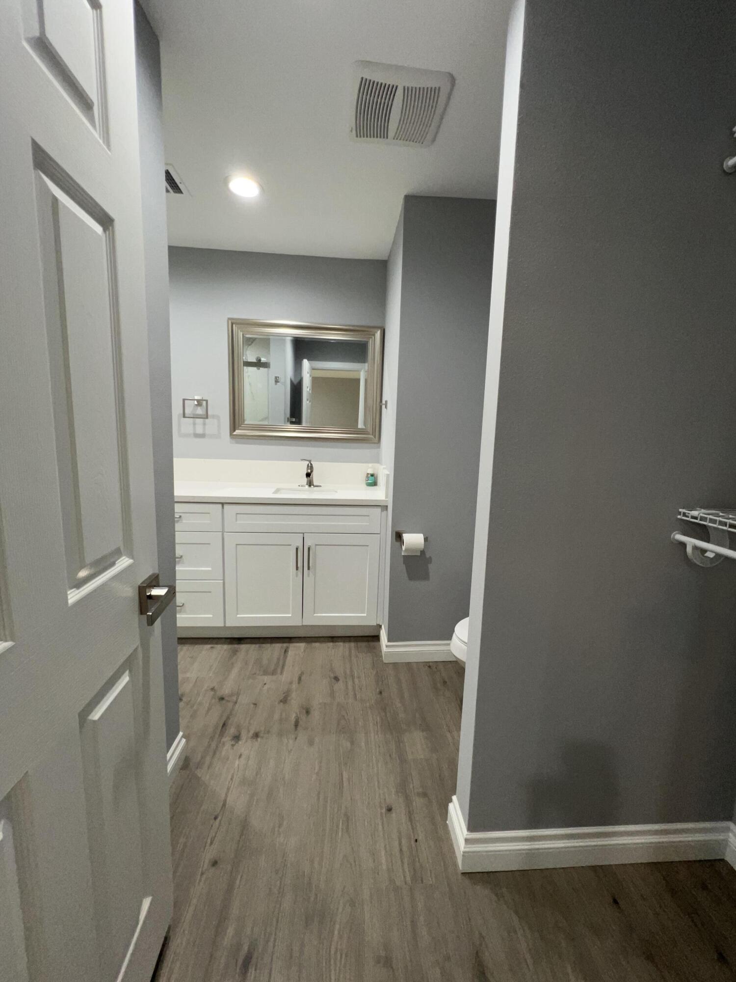 3255 East E Avenue Lancaster, CA 93535 - Photo 57 of 81 a room with wooden floor and mirror