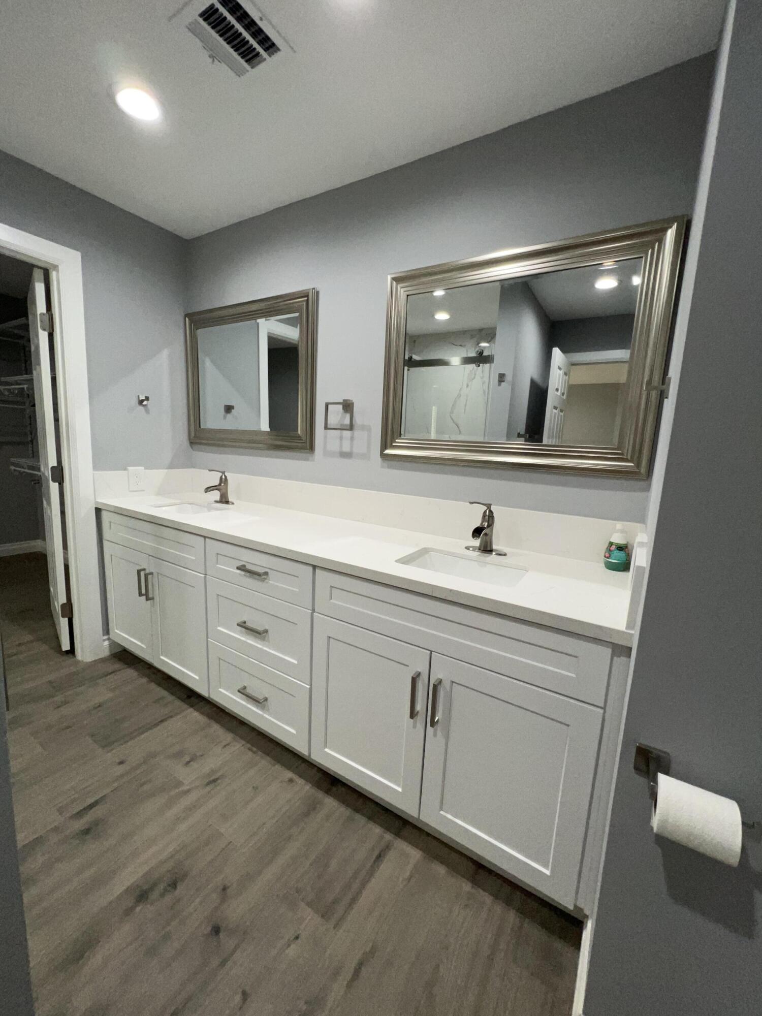 3255 East E Avenue Lancaster, CA 93535 - Photo 59 of 81 a bathroom with a double vanity sink and a mirror