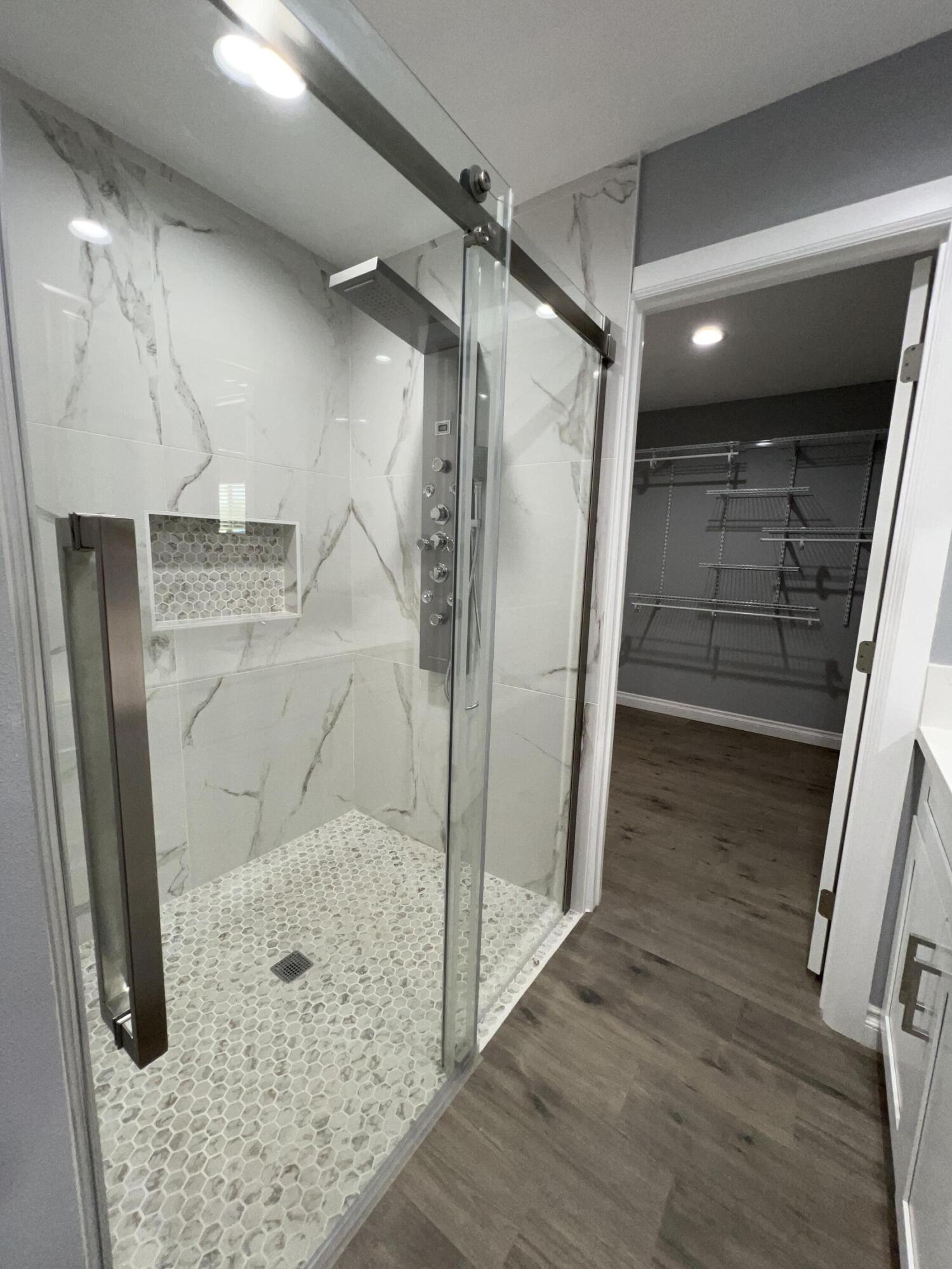 3255 East E Avenue Lancaster, CA 93535 - Photo 61 of 81 a bathroom with a glass shower door and a sink