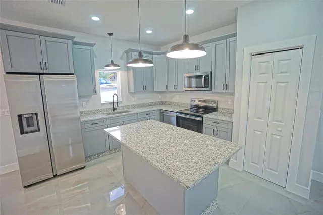 a kitchen with a sink stove and microwave