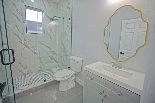 a bathroom with a toilet sink and shower