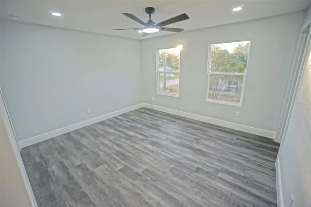 wooden floor in an empty room with a window