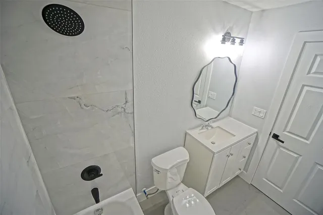 a view of an empty room with closet and wooden floor