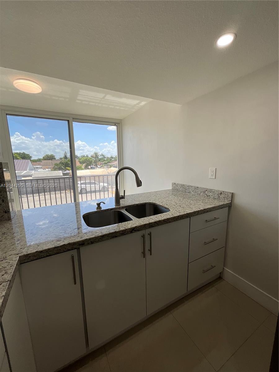 9441 Southwest 4th Street, Unit 214 Miami, FL 33174 - Photo 4 of 22 a kitchen with a sink and a window