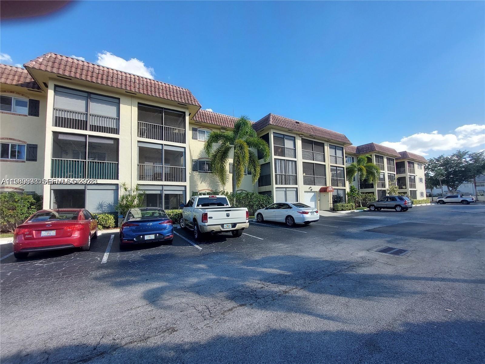 253 South Cypress Road, Unit 214 Pompano Beach, FL 33060 - Photo 25 of 25 a car parked in front of a house