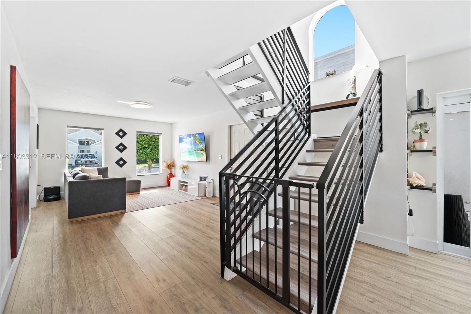 139 Southwest 159th Way Sunrise, FL 33326 - Photo 11 of 40 a view of entryway livingroom and hallway with wooden floor