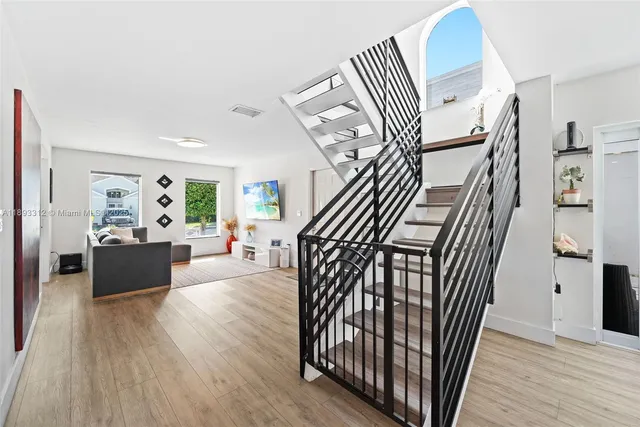 a view of entryway livingroom and hallway with wooden floor