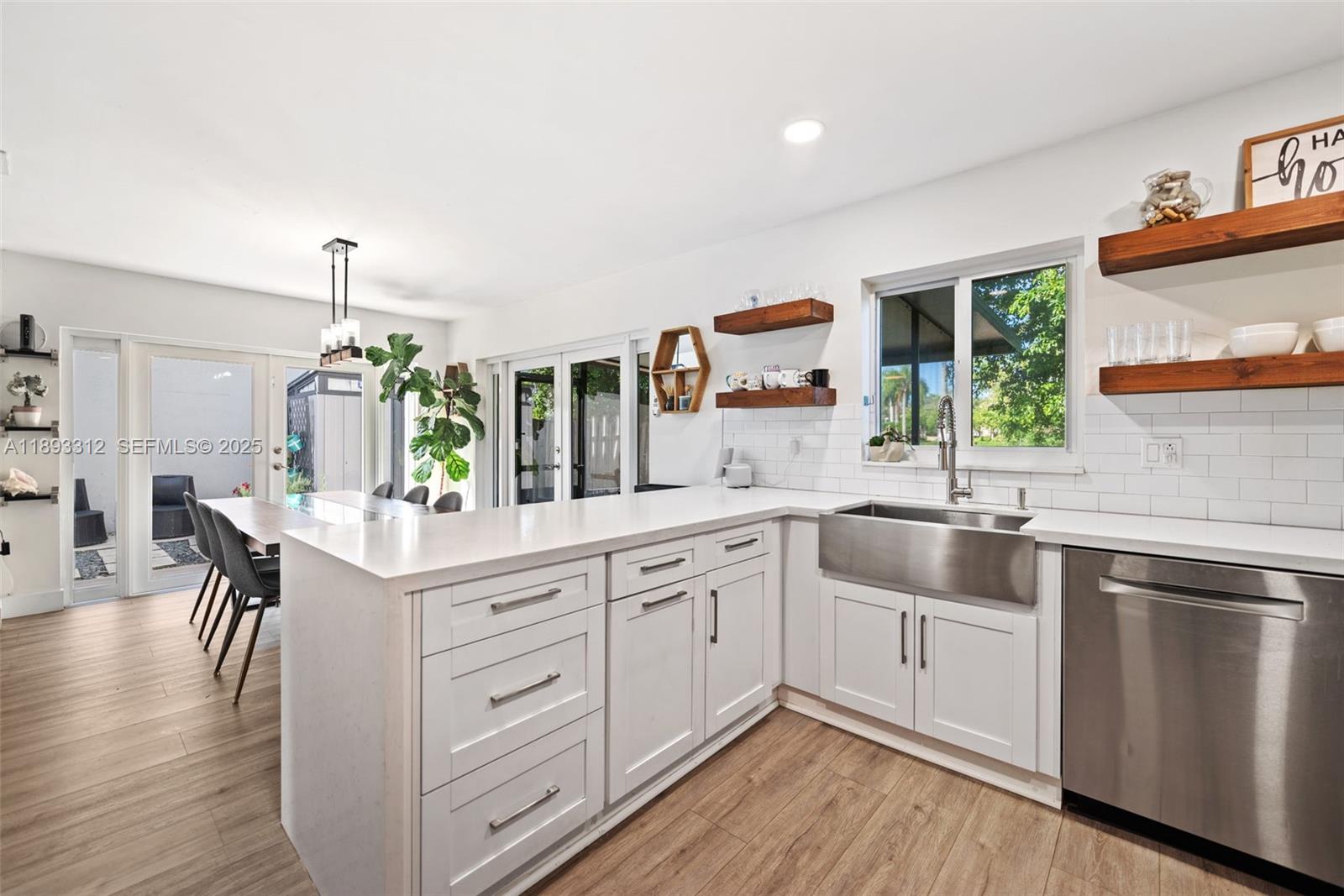 139 Southwest 159th Way Sunrise, FL 33326 - Photo 16 of 40 a kitchen with a sink stove and cabinets