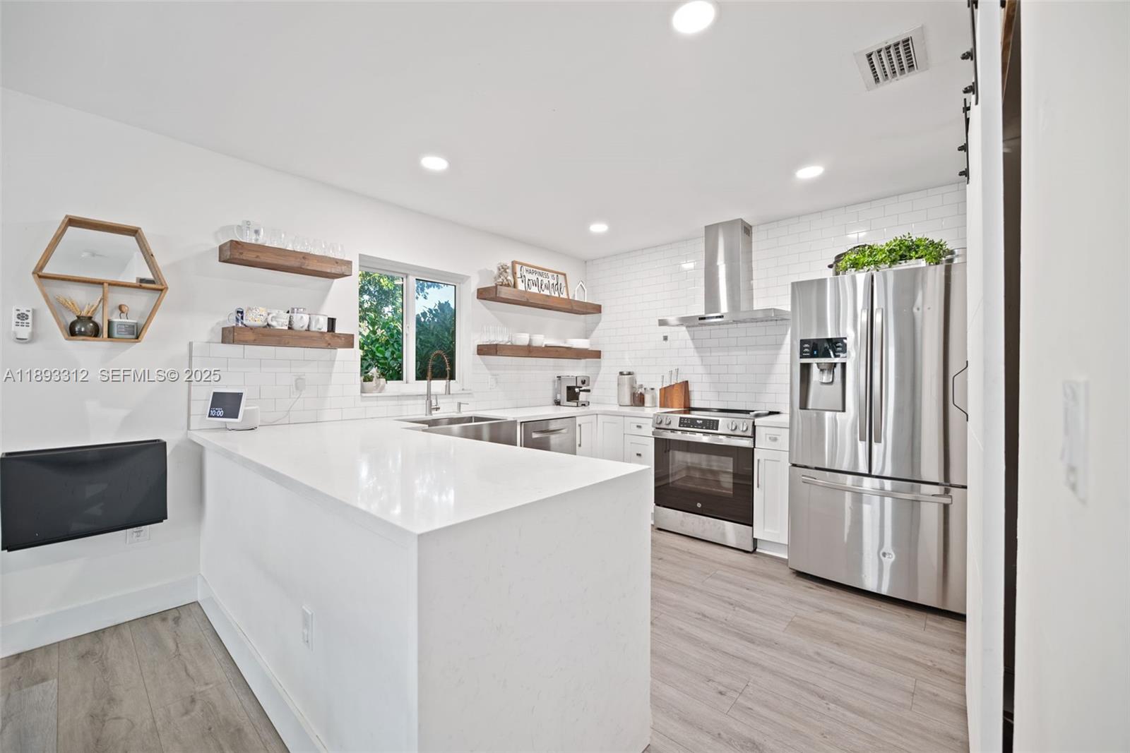 139 Southwest 159th Way Sunrise, FL 33326 - Photo 19 of 40 a kitchen with stainless steel appliances a refrigerator sink and microwave