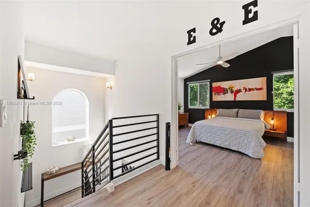 a bedroom with furniture and a window