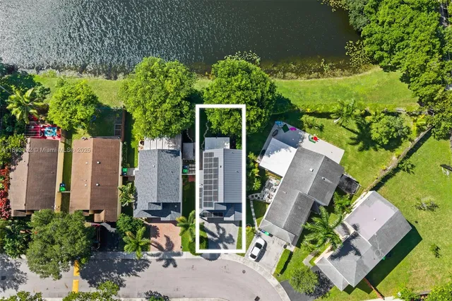 an aerial view of a house with a yard and garden