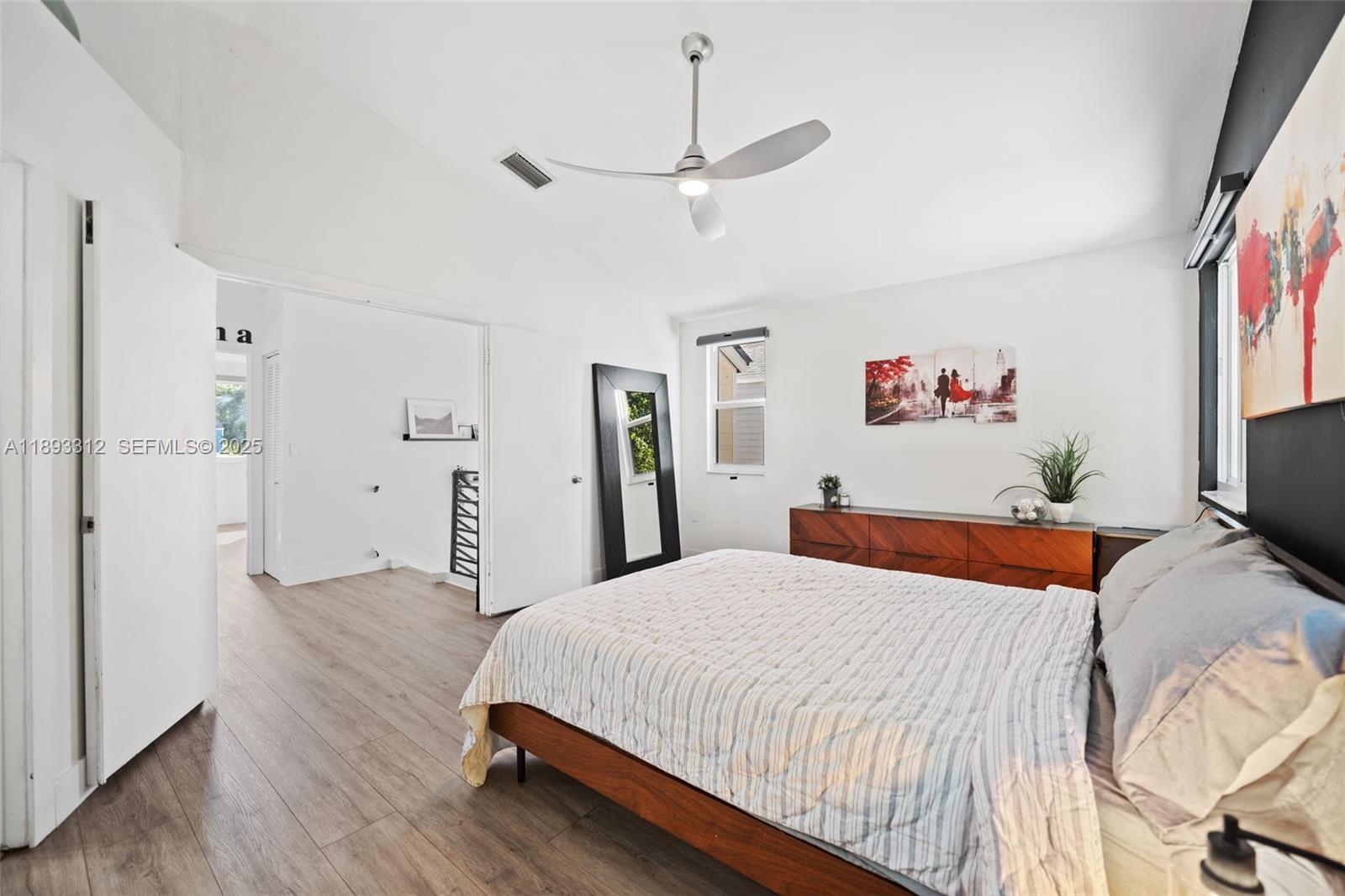 139 Southwest 159th Way Sunrise, FL 33326 - Photo 21 of 40 a bedroom with a bed and a flat screen tv