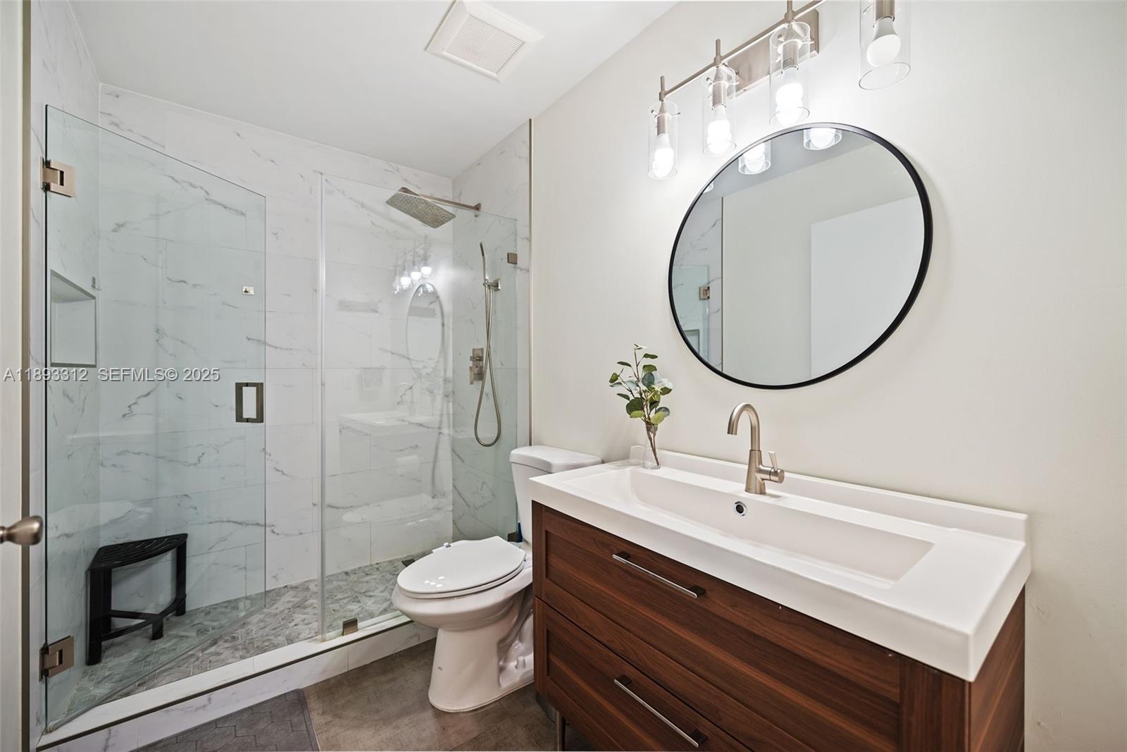 139 Southwest 159th Way Sunrise, FL 33326 - Photo 22 of 40 a bathroom with a toilet a sink and mirror