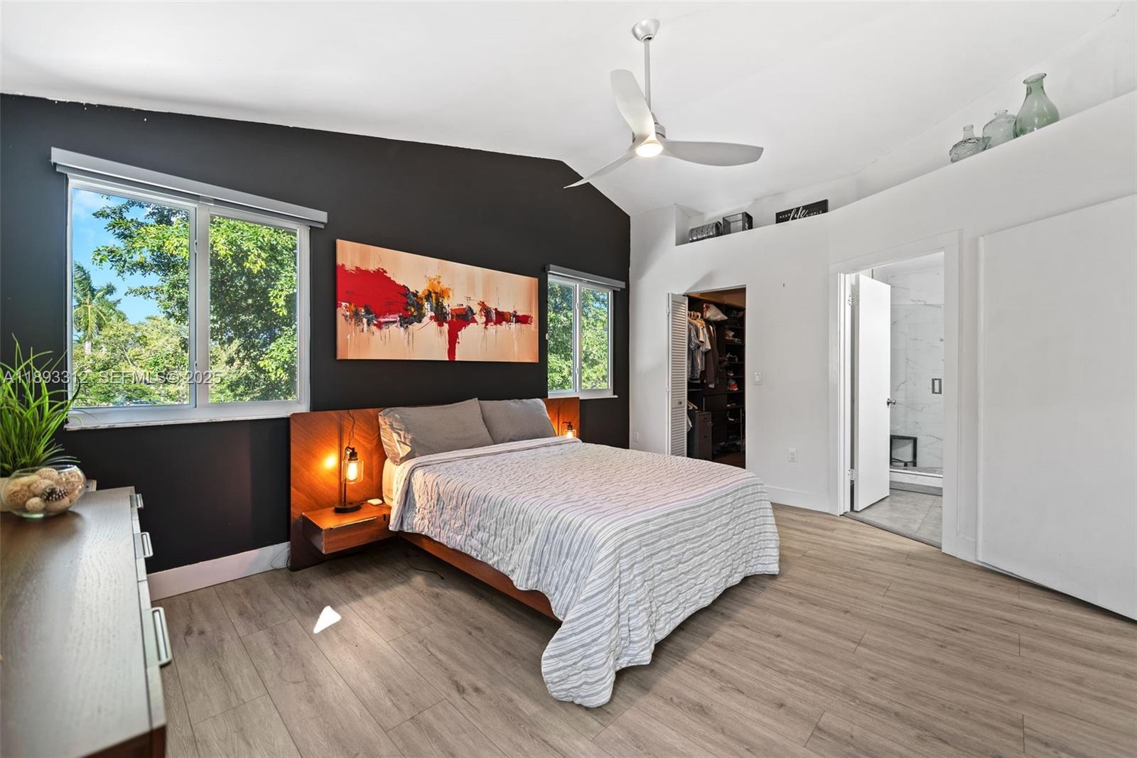 139 Southwest 159th Way Sunrise, FL 33326 - Photo 23 of 40 a bedroom with a bed and a flat screen tv