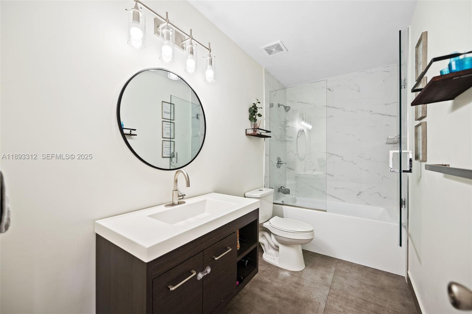 139 Southwest 159th Way Sunrise, FL 33326 - Photo 24 of 40 a bathroom with a sink a toilet and a mirror