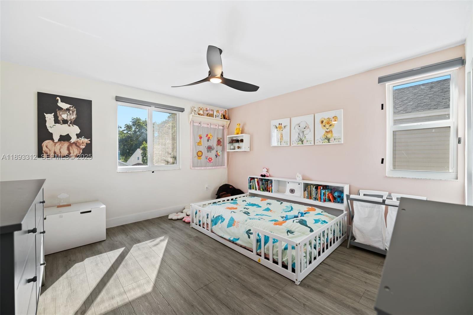 139 Southwest 159th Way Sunrise, FL 33326 - Photo 25 of 40 a bedroom with a bed and wooden floor