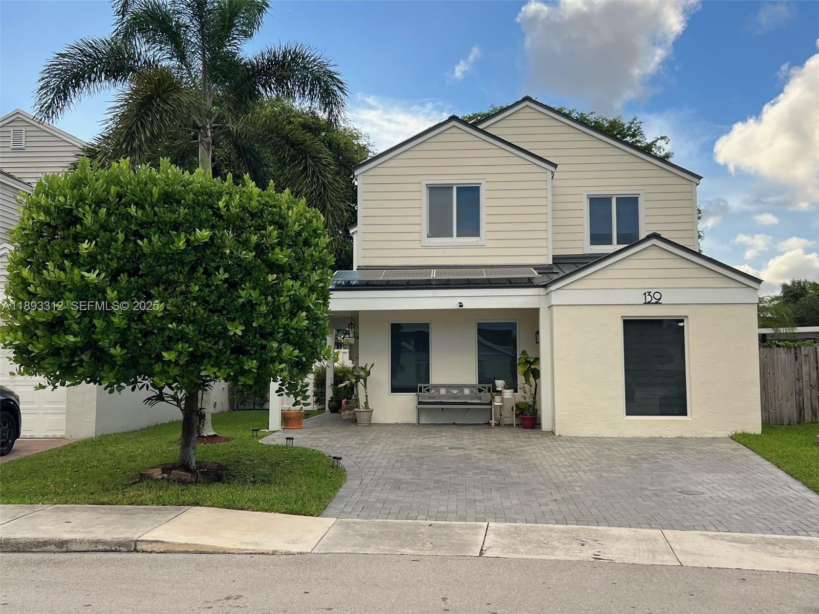 139 Southwest 159th Way Sunrise, FL 33326 - Photo 39 of 40 a view of a white house with a large tree