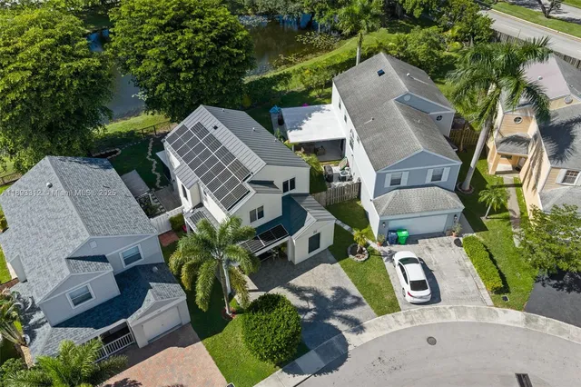 an aerial view of a house with garden space and street view