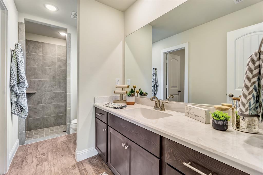 4713 Enclave Drive Sanger, TX 76266 - Photo 12 of 12 a bathroom with a sink and a mirror