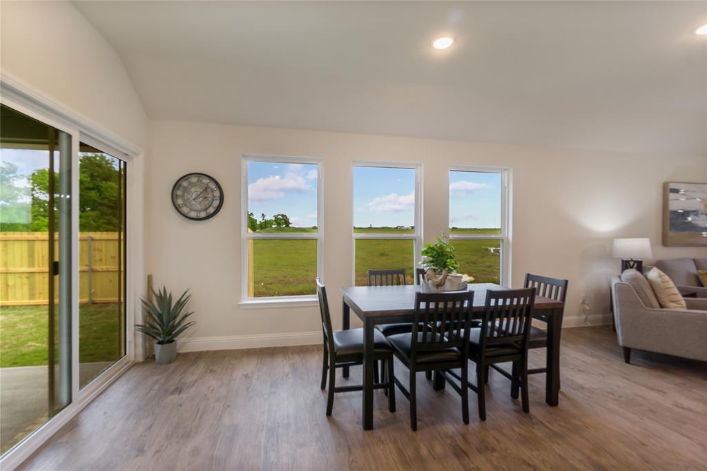 4713 Enclave Drive Sanger, TX 76266 - Photo 8 of 12 a view of a dining room with furniture window and wooden floor