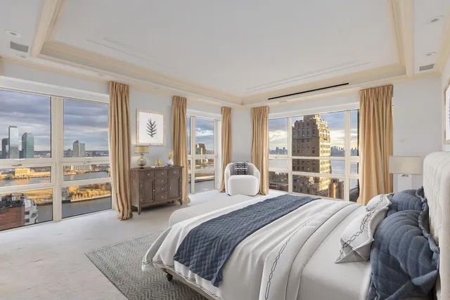 a bedroom with a large bed and a balcony