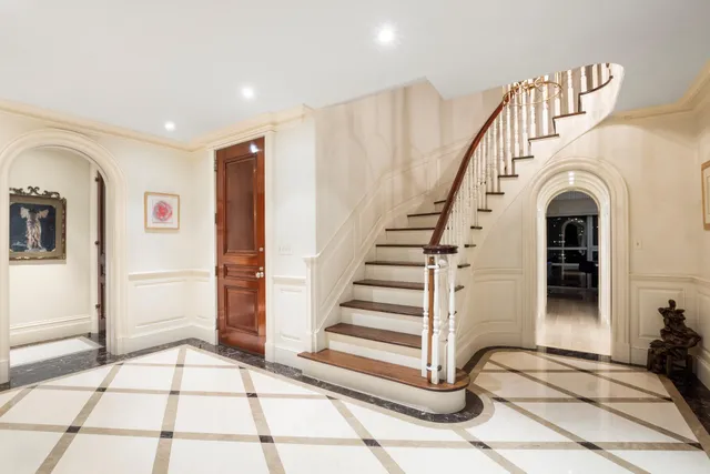 a kitchen with white cabinets and sink