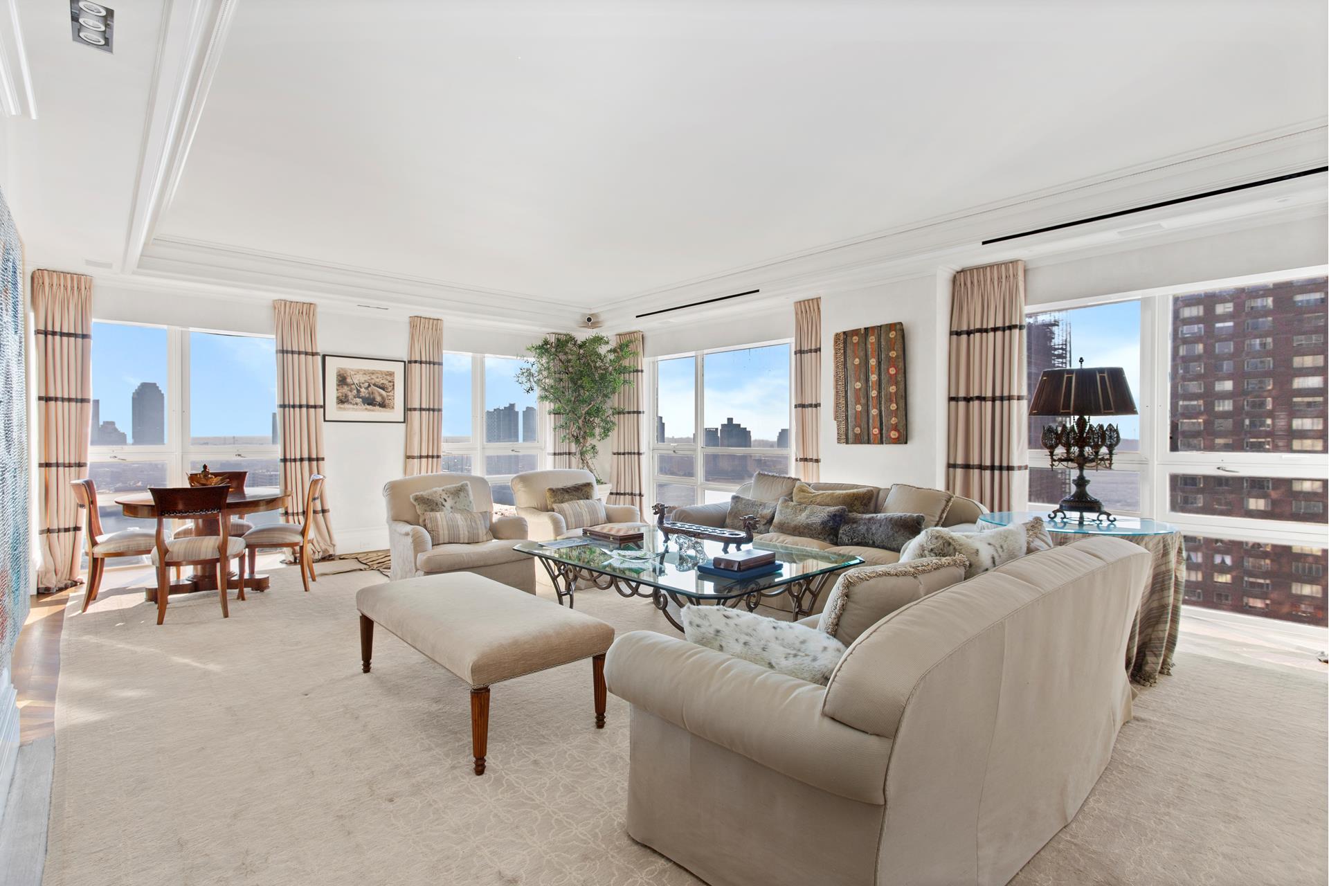 415 East 54th Street, Unit 25GG Manhattan, NY 10022 - Photo 2 of 30 a living room with furniture and a large window