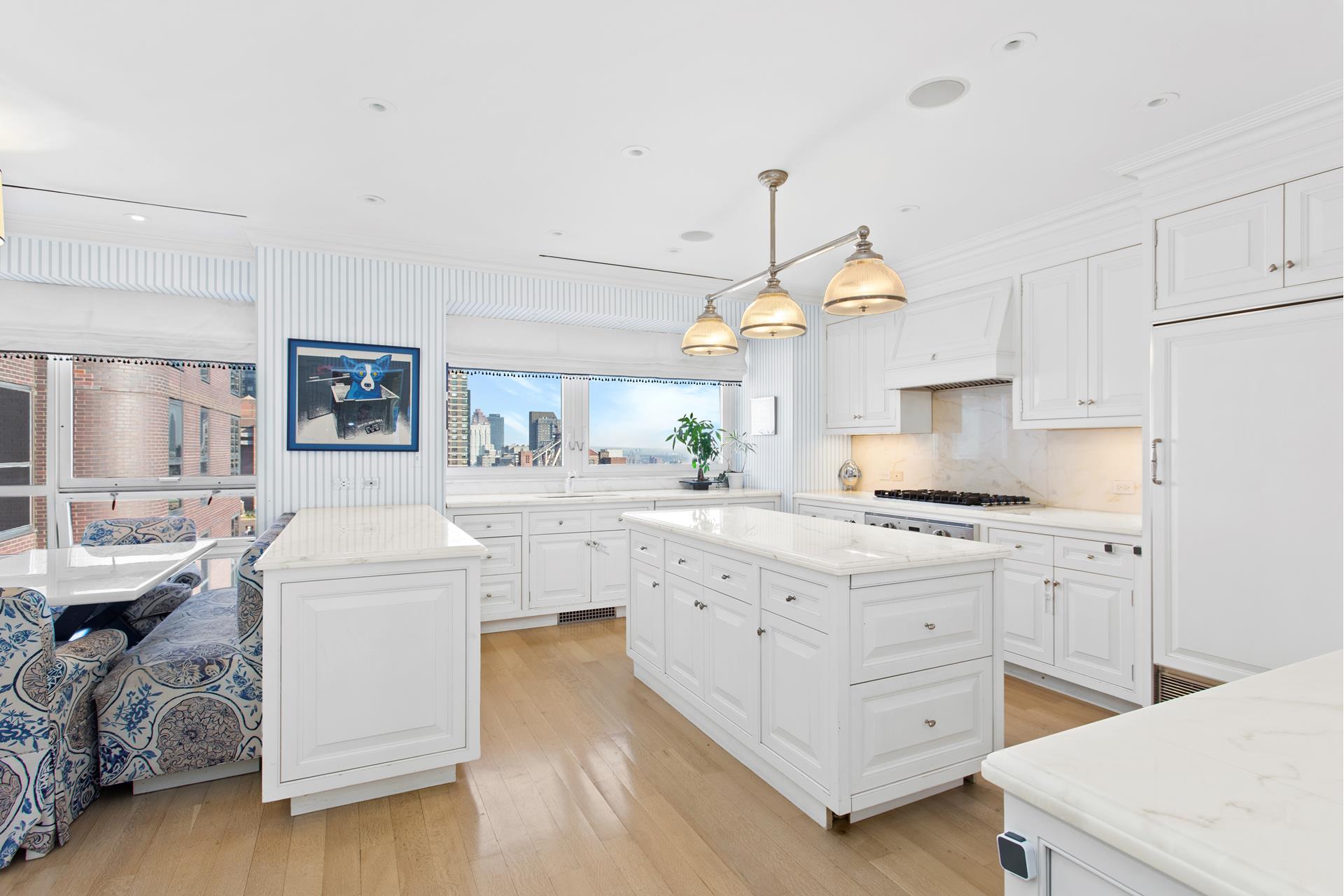 415 East 54th Street, Unit 25GG Manhattan, NY 10022 - Photo 6 of 30 a kitchen with white cabinets and sink