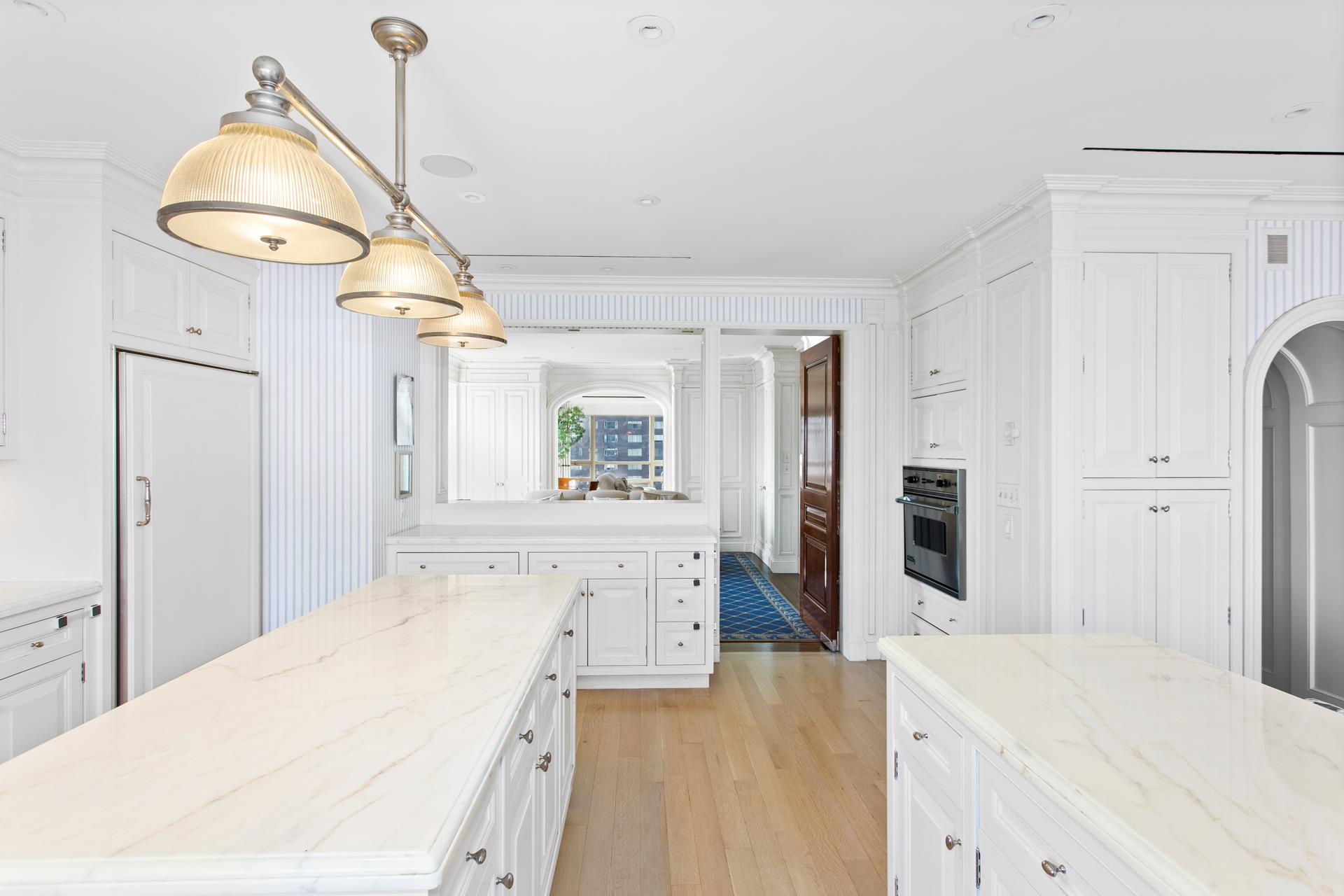 415 East 54th Street, Unit 25GG Manhattan, NY 10022 - Photo 7 of 30 a spacious bathroom with a sink a mirror and a shower