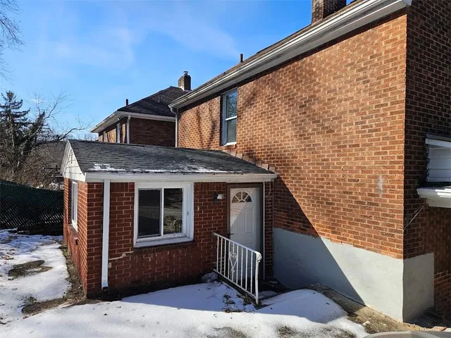 a front view of a house with wooden stairs